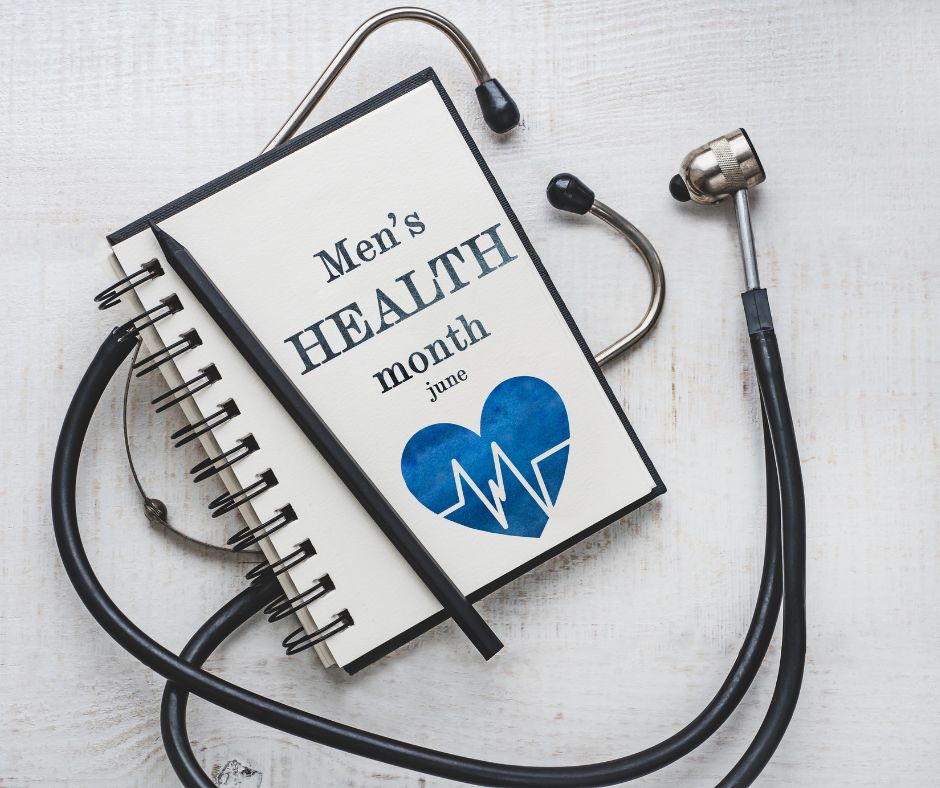 a notebook with a page writing "men's health month june" and a blue heart, a black pen and a stethoscope around the notebook